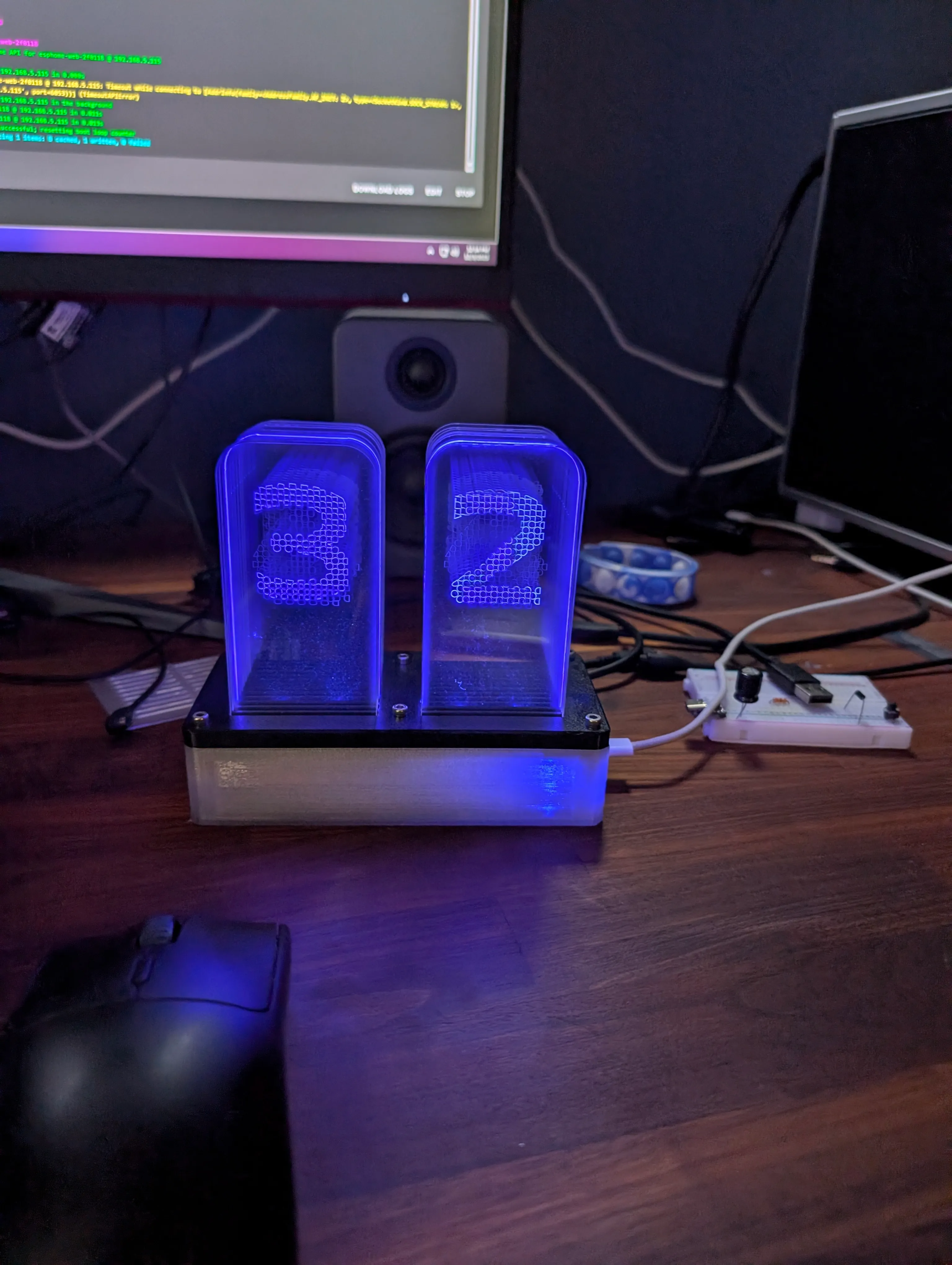 The finished thermometer glowing blue, reading 32, on a desk