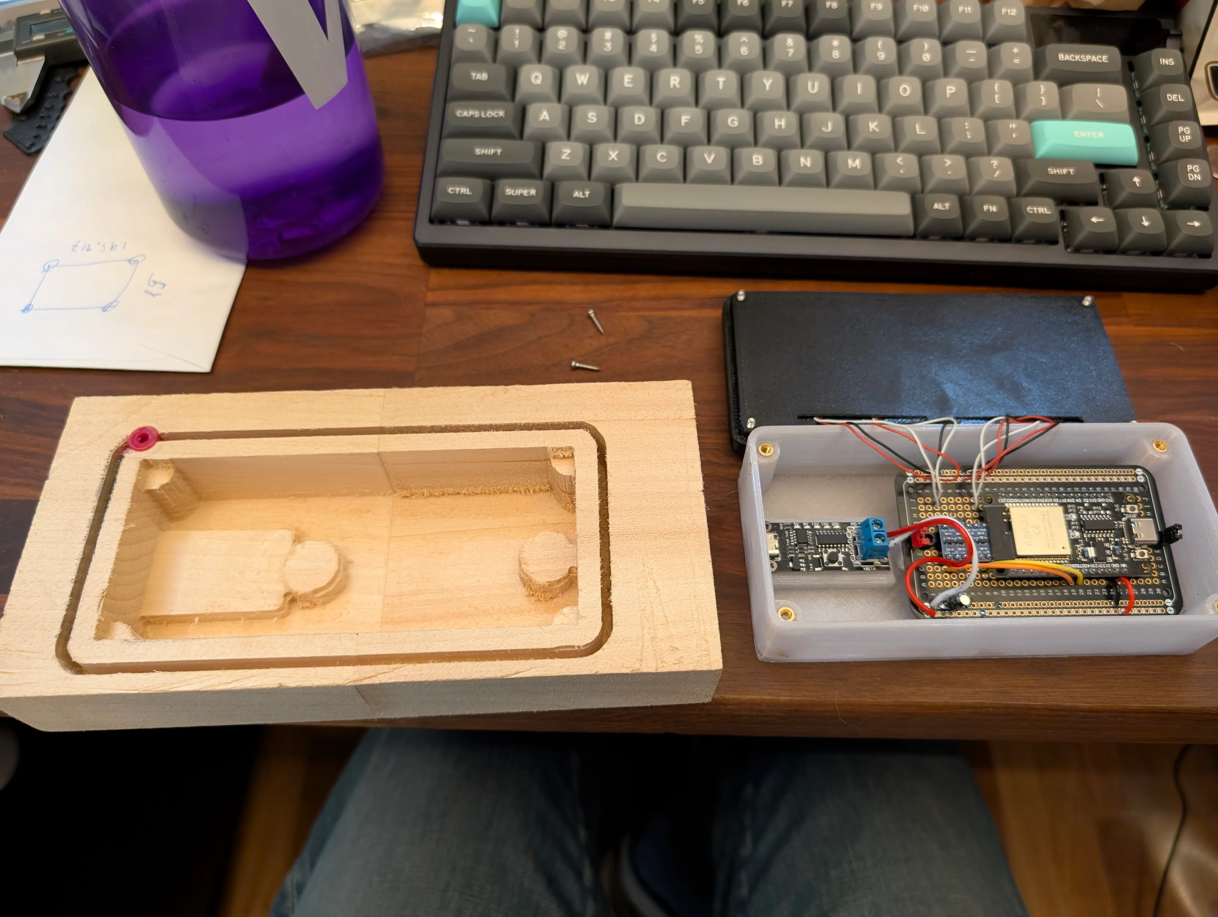 The open base showing the ESP32 board, wiring, and the machined wooden enclosure half