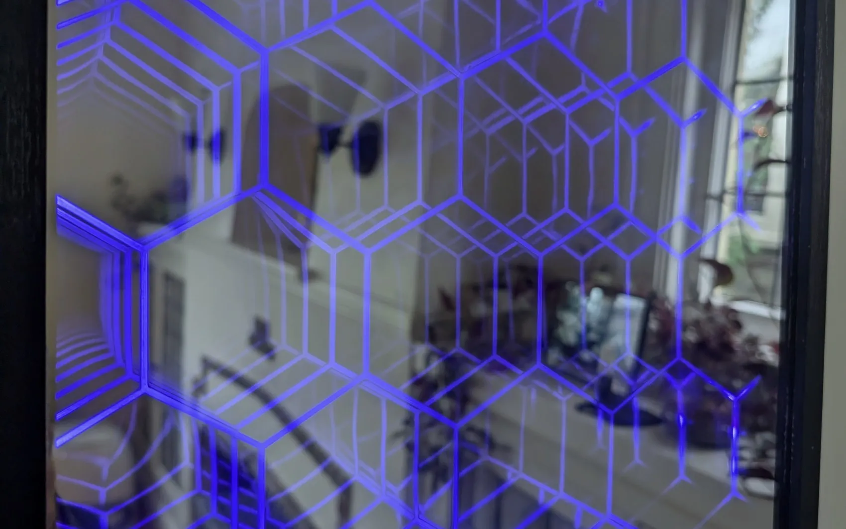 The mirror powered on, its hexagonal pattern receding into an apparent tunnel of light